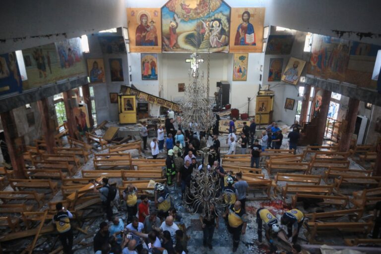 People-and-rescuers-inspect-the-damage-at-the-site-of-a-reported-suicide-attack-at-the-Saint-Elias-church-in-Damascus